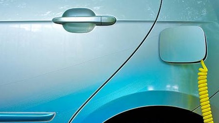 Blue electric vehicle being charged